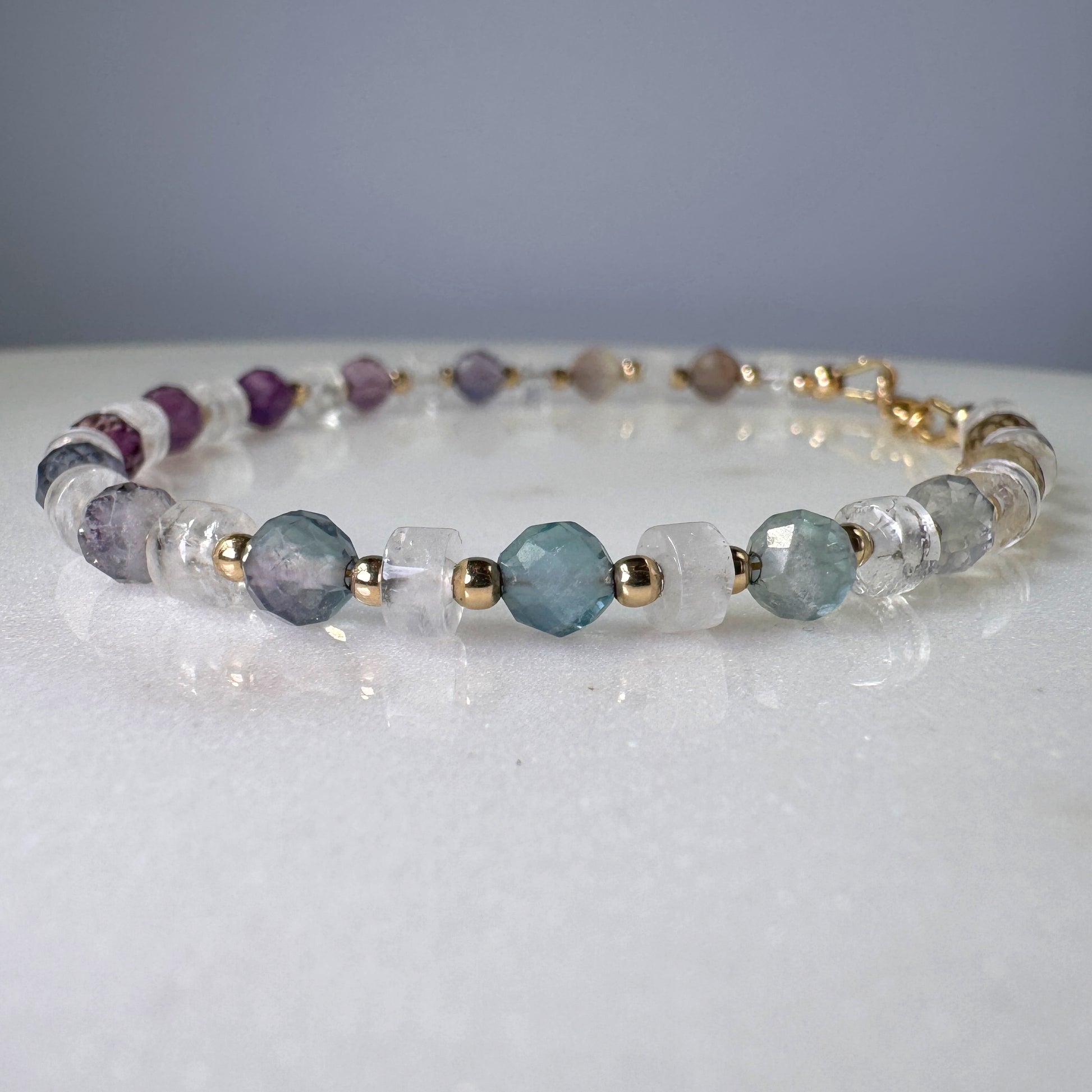 Beaded bracelet with multicolored beads on a white surface