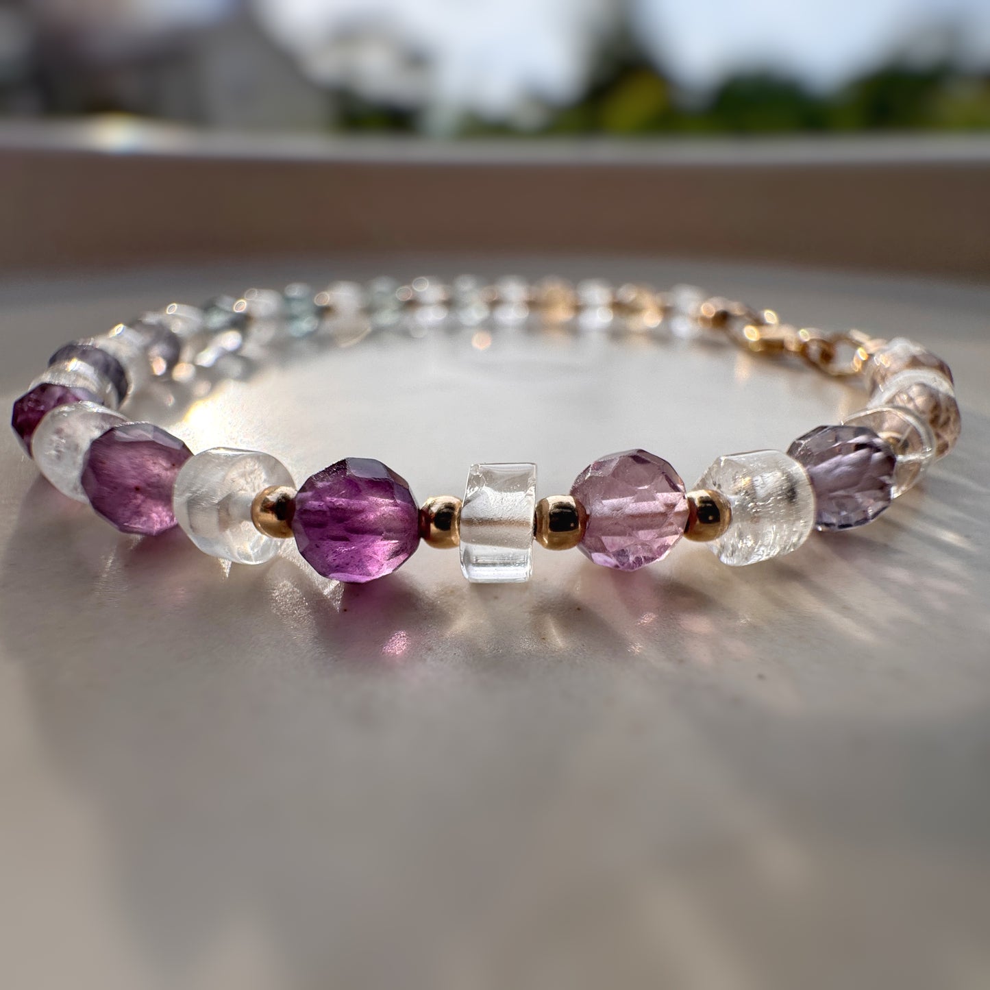 rainbow fluorite beaded bracelet with quartz and 14k gold filled accents in sunlight